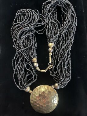 Multi-Strand Black Beaded Necklace with Hammered Gold Pendant